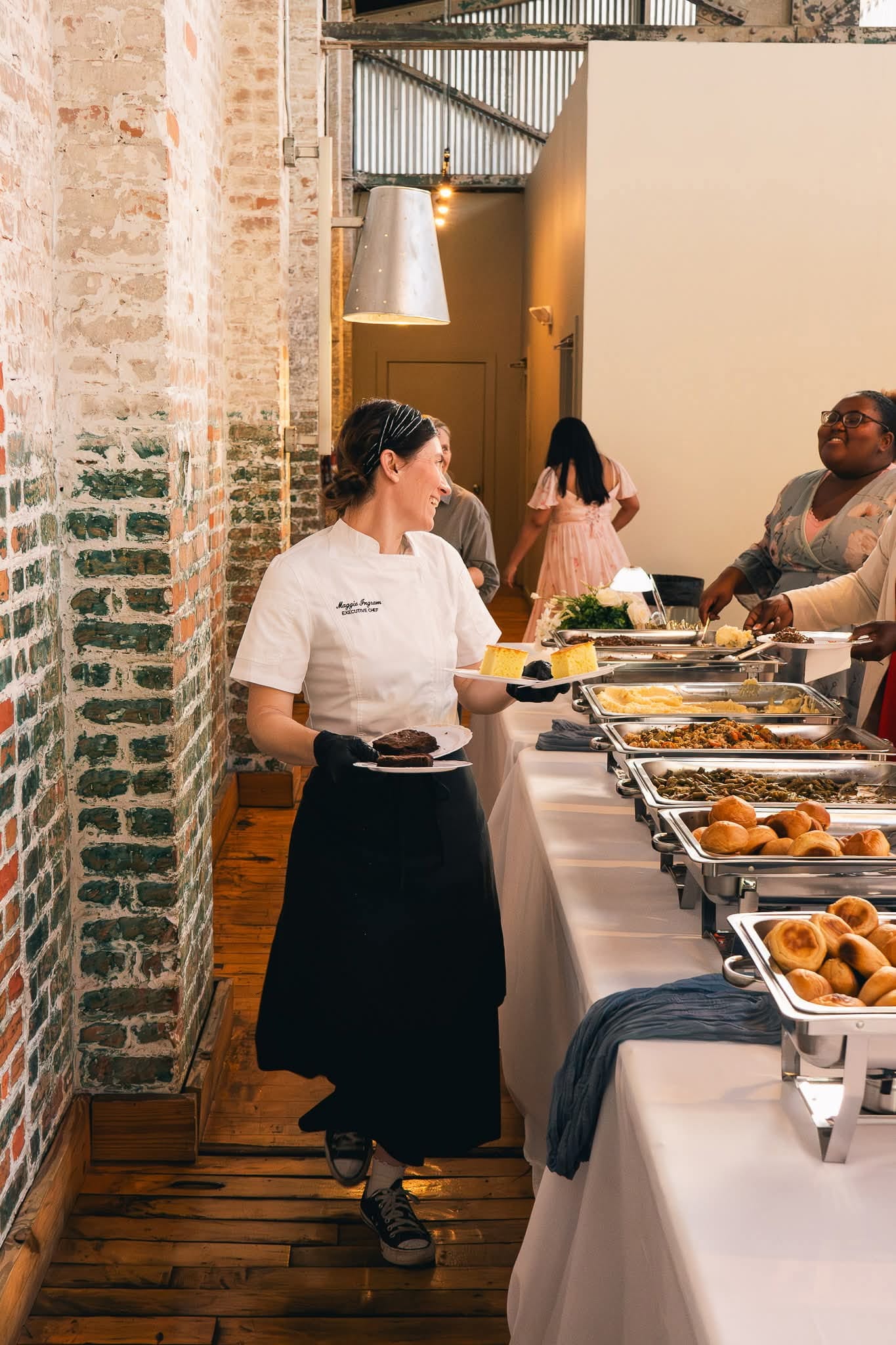 Full Southern buffet line with mashed potatoes, greens, rolls, and carved meats