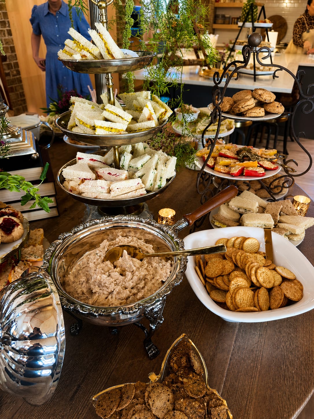 Grazing table spread with tea sandwiches, house dip, crackers, and scones