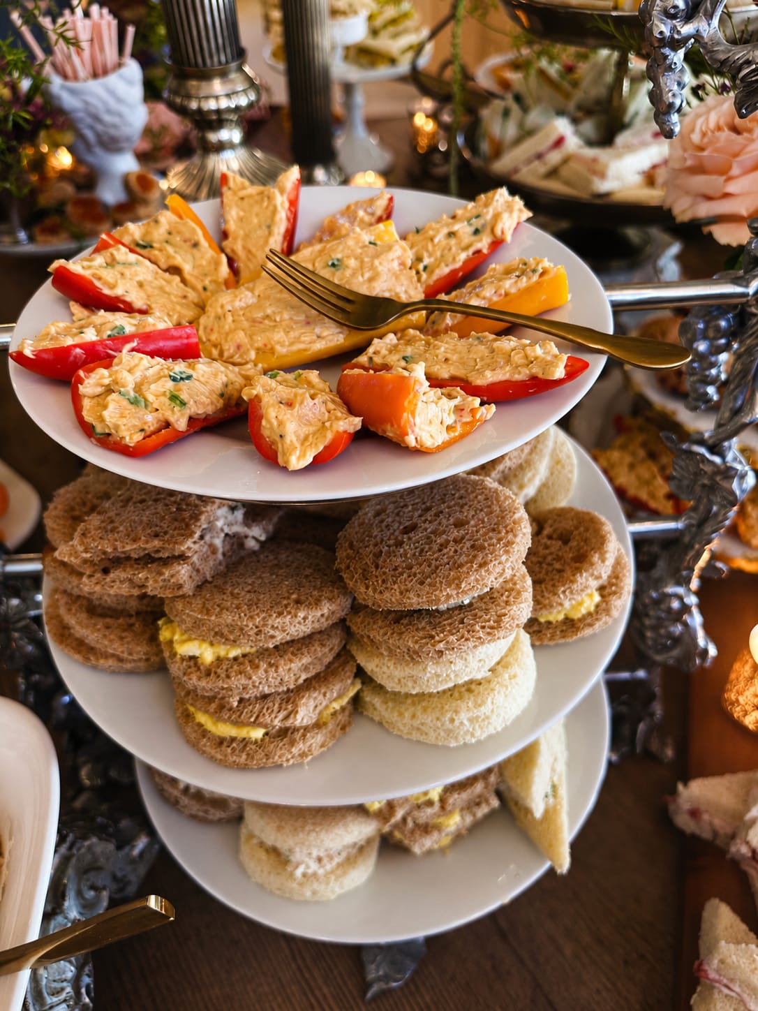 Tiered tea tower with pimento-stuffed peppers and finger sandwiches