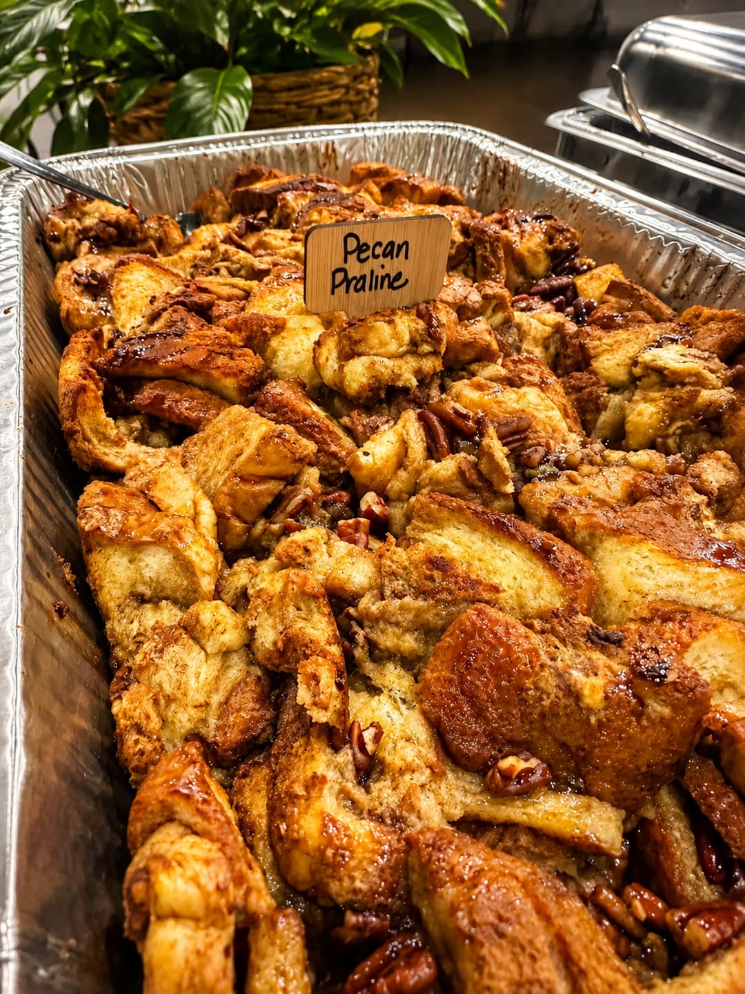 Maggie's Pecan Praline in a catering tray with a hand-lettered wooden sign